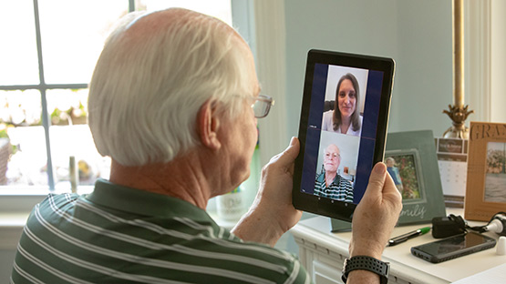 Saint Vincent Hospital patient using his tablet to have a video visit.