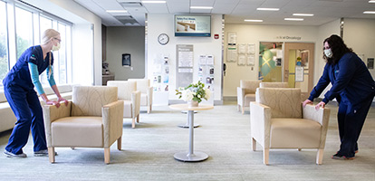AHN nurses pulling chairs apart to ensure proper social distancing in waiting room