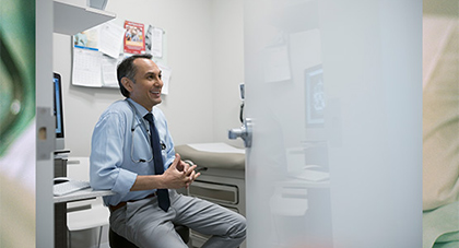 AHN doctor smiling as he speaks with his patient